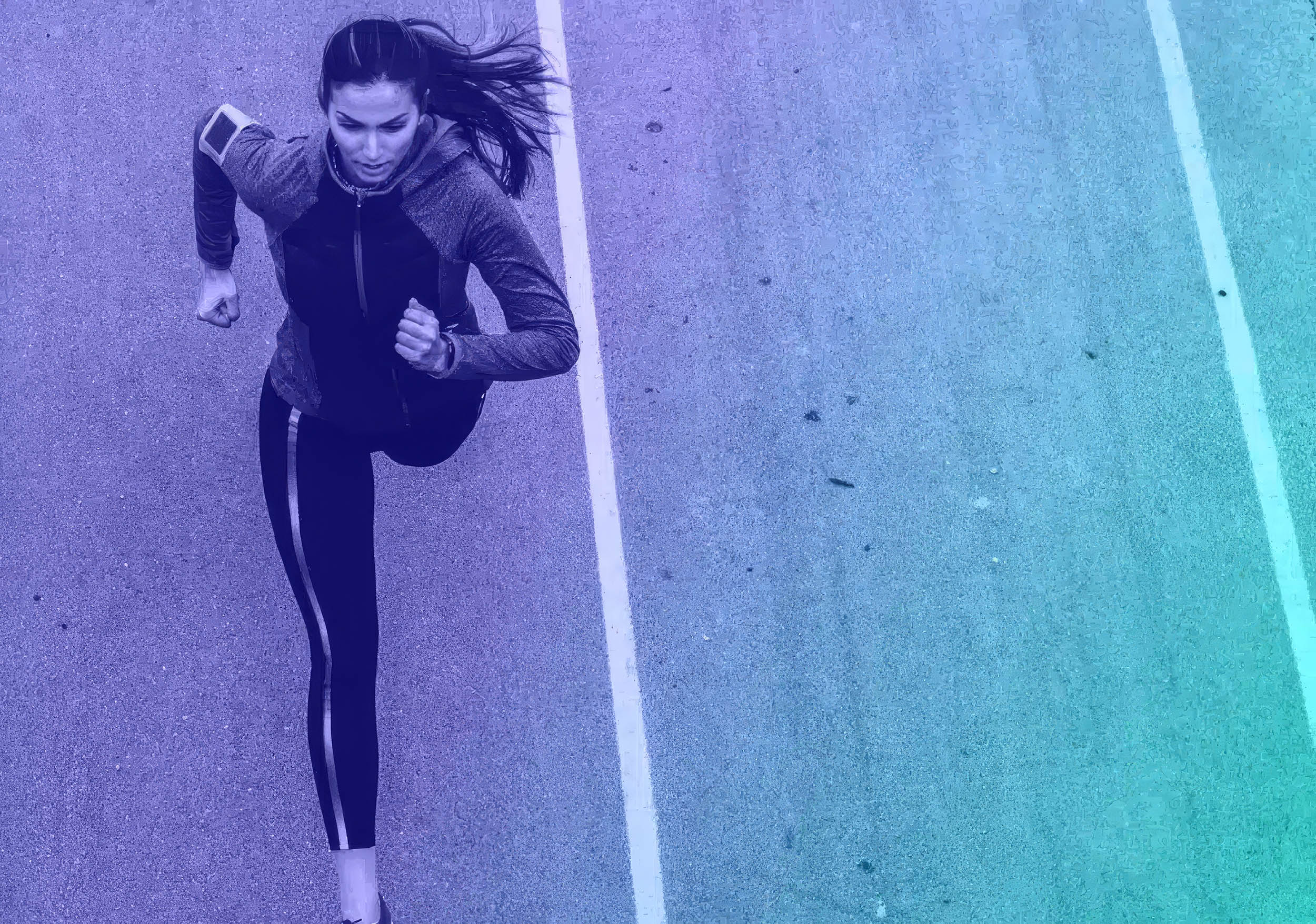 Female runner training on a road viewed from above